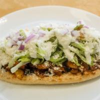 Huarache · Bigger version is a sope. Homemade maza tortilla with choice of meat. Topped with beans, let...