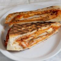 Chicken Parm Panino · Hand bread chicken cutlet topped with homemade sauce and Mozzarella cheese. Served with chips.