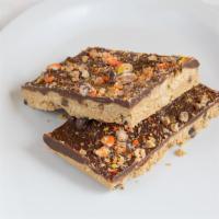 Peanut Butter Crack · Think of Reese's peanut butter cup with chocolate chips inside sprinkled with Reese's pieces.