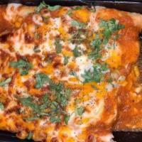 Enchilada De Pollo · Three corn tortilla filled with chicken, roasted chile salsa melted cheese.