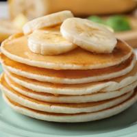 Pancakes With Banana Slices · Served with 3 buttery pancakes cooked to perfection and topped with slices of banana.