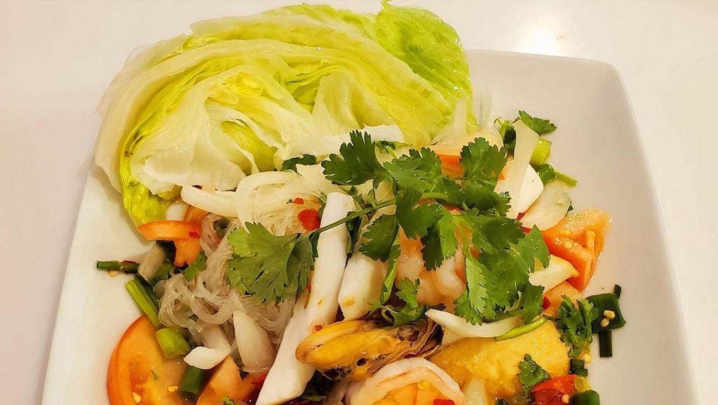 Spicy Seafood Salad · Shrimps, calamari, sliced fish cakes, glass noodle, tomato, white and green onion in spicy lime dressing.