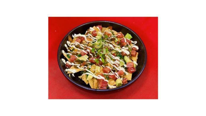 Tuna Poke Nachos Gf · Crispy corn tortilla, seaweed salad, pico de gallo jalapenos, avocado, wasabi aioli, sesame seeds, and cilantro.