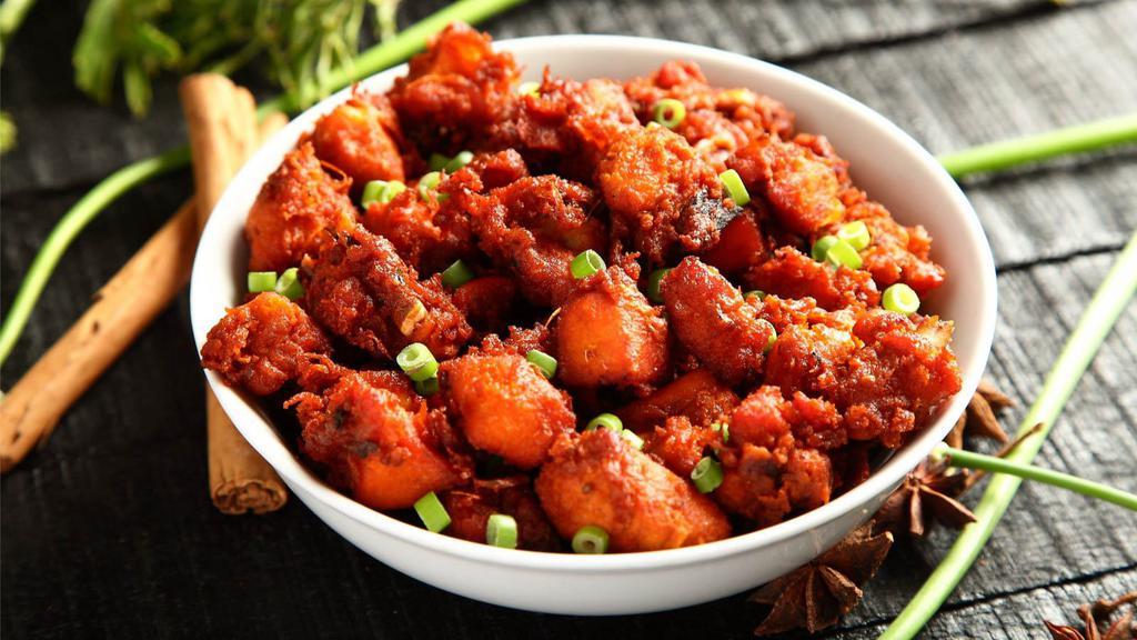 Chicken 65 · Cubes of chicken cooked in spicy red sauce with whole red chillies and curry leaves.