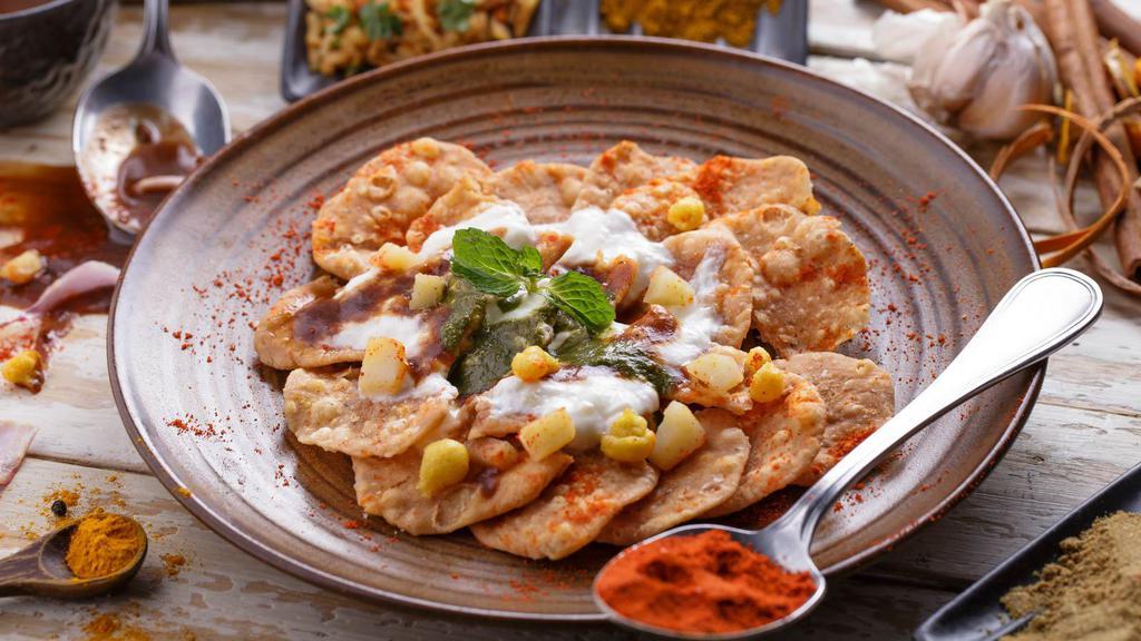 Dahi Papdi Chaat · Crispy crackers with boiled potatoes, chickpeas, mint & tamarind chutney and yogurt.