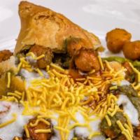 Aloo Tikki Chat · Spicy potato cakes served with seasoned chickpeas tamarind & mint chutney.