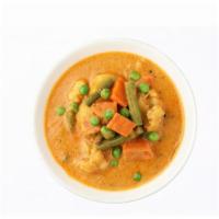 Navratan Korma · Delicious melange vegetables cooked in a curry sauce garnished with dry fruits.