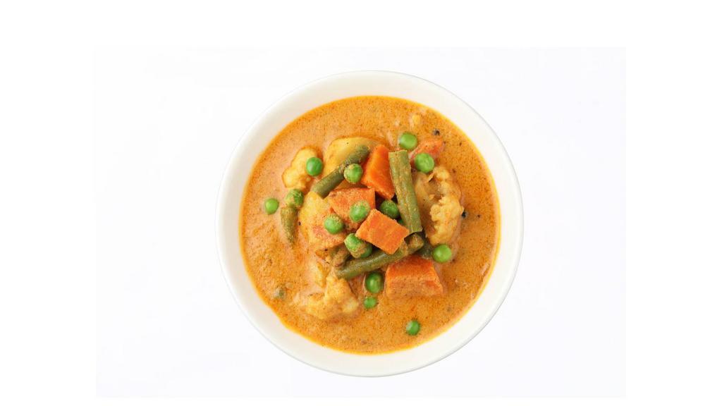 Navratan Korma · Delicious melange vegetables cooked in a curry sauce garnished with dry fruits.
