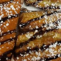 Nutella Poppers  · Pastry filled with Nutella and topped with powdered sugar and chocolate drizzle - Seven to a...