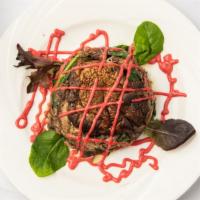 Duck Confit · On portobello mushrooms & baby spinach raspberry & walnut vinaigrette.
