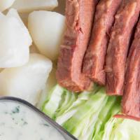 Corned Beef & Cabbage · Served w/ boiled potatoes topped w/ a white parsley sauce
