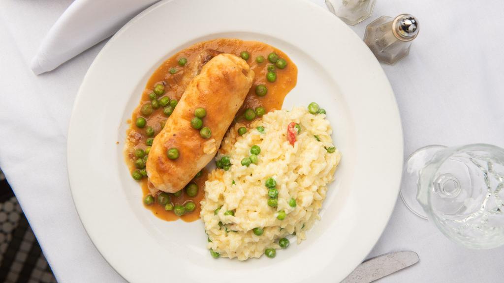 Chicken Rollantini · Served over sweet pea & roasted red pepper, parmesan risotto.