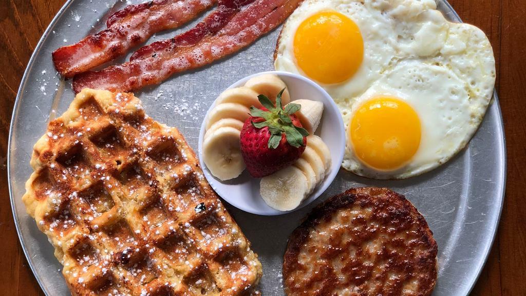 The Belgian Breakfast · Two eggs any style, 2 bacon strips, 1 sausage patty and an original waffle. OUT OF SAUSAGE WILL COME WITH 4 strips of bacon.