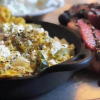 Greek · Four scrambled eggs cooked with peppers, onions, feta cheese and sprinkled with organic Gree...