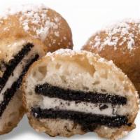Fried Oreos · Deep Fried Oreo cookies topped with Hershey’s Chocolate drizzle and powdered sugar.