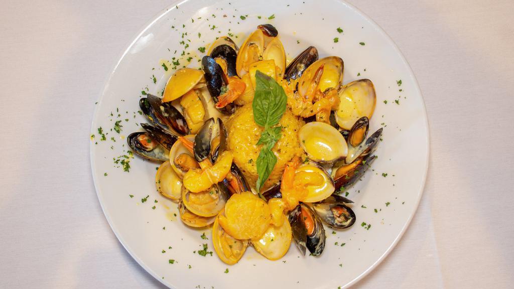 Seafood Risotto · Clams, mussels, shrimp, scallops, saffron cream sauce.