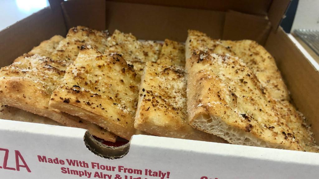 Sq Garlic Bread - Half Pan  · Garlic, parmesan and e.v.o.o. with our bread made with Italian flour!
