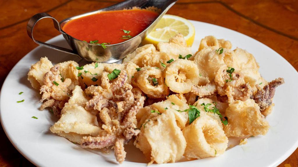 Calamari Fritti · Fried squid in a light batter with tomato sauce on the side.