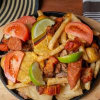 Picada La Santa · Colombian sausage, fried pork skins, fried potato, sirloin steak. morcilla