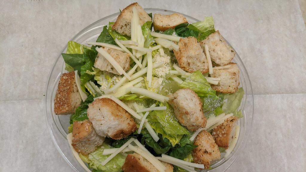 Grilled Chicken Caesar Salad · Fresh Romaine, Shaved Parmesan Cheese, Garlic Croutons with Caesar Dressing, Topped with Grilled Chicken Slices.