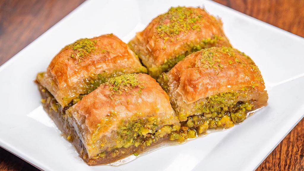 Baklava · Sweet pastry made of extremely thin sheets of phyllo dough layer with chopped nuts and honey syrup baked with butter and cut into diamonds.
