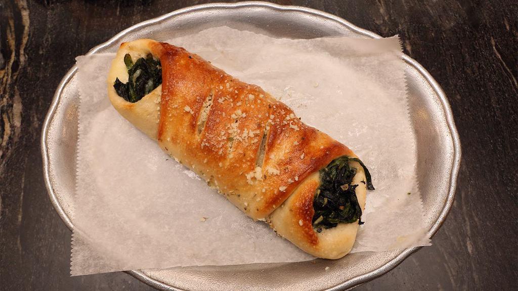 Spinach Roll · Pizza dough rolled with spinach, mozzarella and ricotta cheeses. Served with side of fresh marinara sauce.