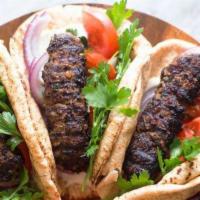 Kofta Kabab (Ground Lamb Or Beef) · Ground lamb or beef marinated in fresh parsley, onions and grated spices. Broiled over natur...