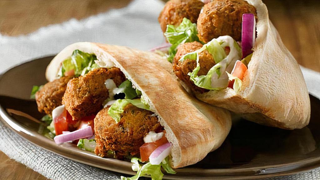 Falafel (Chick Peas) · Deep fried ground chickpeas, parsley, tahini and spices. Served with salad in pita bread envelope.