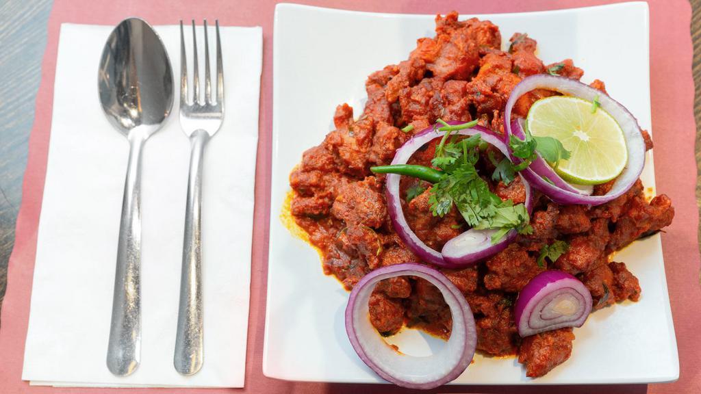 Hyderabadi Chicken 65 · Boneless cubes of chicken marinated with Indian spices and deep-fried and sautéed with slight gravy.