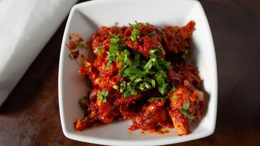 Gobi Manchurian With Gravy · Cauliflower florets stir fried in a wok with soy sauce and green chilies.