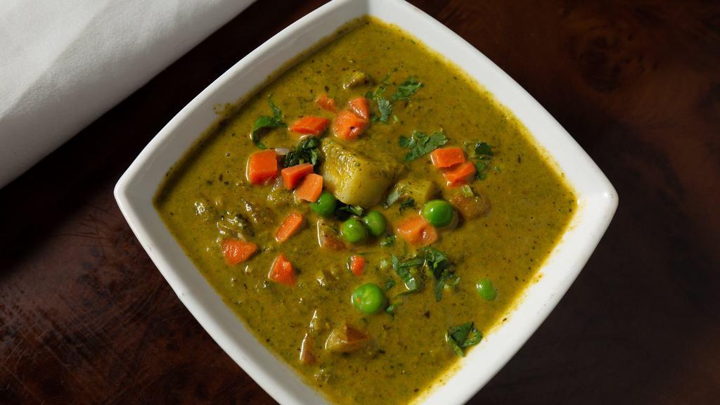 Aloo Palak · Potatoes with spinach and finely chopped coriander cooked with turmeric, paprika, and spices.