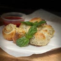 Garlic Knots (6) · A classic snack, our garlic knots are strips of pizza dough tied in a knot, baked, and then ...