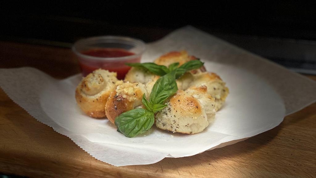 Garlic Knots (6) · A classic snack, our garlic knots are strips of pizza dough tied in a knot, baked, and then topped with melted butter, garlic, and parsley.
