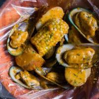 New Zealand Green Mussels (1 Lb) · Served with corn, potatoes, and a choice of sauce.