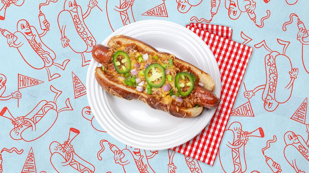 The Chili Cheese Dog · Hot dog topped with chili, jalapenos, sliced onion, scallions, and shredded cheese, served on a fluffy bun.