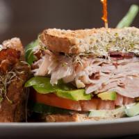Turkey Club Sandwich · Delicious sandwich made with slices of turkey, bacon, lettuce, tomatoes, and mayo. Served wi...