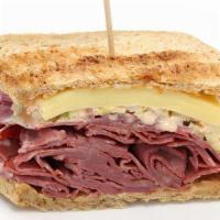 Reuben Corned Beef Sandwich · Delicious Sandwich made with Corned Beef, Swiss sauerkraut, and Russian dressing, served on ...