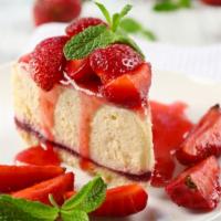 Strawberry Cheesecake · New York style cheesecake slice topped with fresh strawberries.