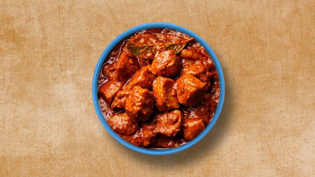 Classic Chicken Tikka Triumph · Chunks of roasted chicken cooked in onion tomato-based gravy and aromatic spices. Served with a side of rice.