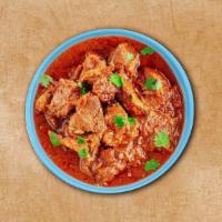Vindaloo Lamb  · Fiery red Indian curry dish of tender lamb chunks cooked in vindaloo sauce made from caramel...