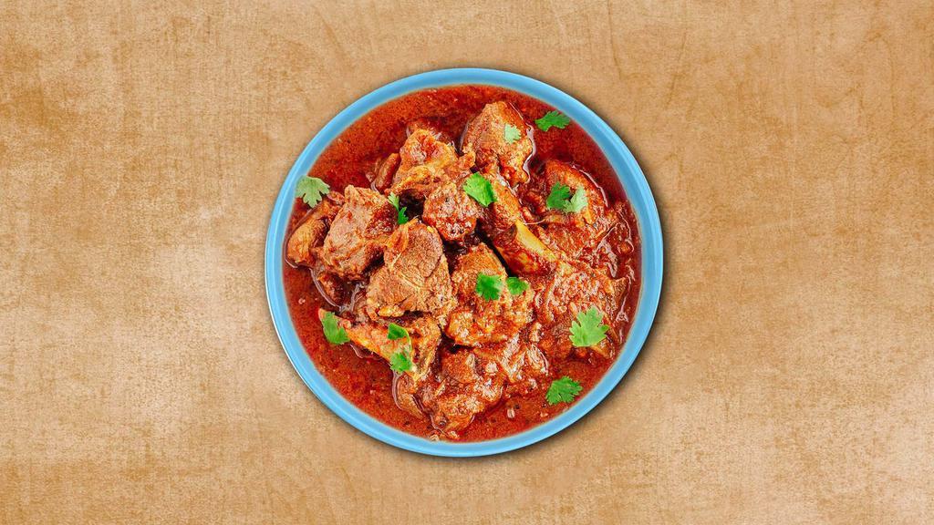 Vindaloo Lamb  · Fiery red Indian curry dish of tender lamb chunks cooked in vindaloo sauce made from caramelized onions, curry paste, coconut milk, vinegar, ginger, chilies, jalapeno, garlic, chickpeas, lentils, pepper, paprika, and turmeric. Served with a side of rice.