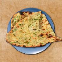 Garlic Naan · A leavened flatbread pressed with minced garlic, baked in a clay oven. A perfect accompanime...
