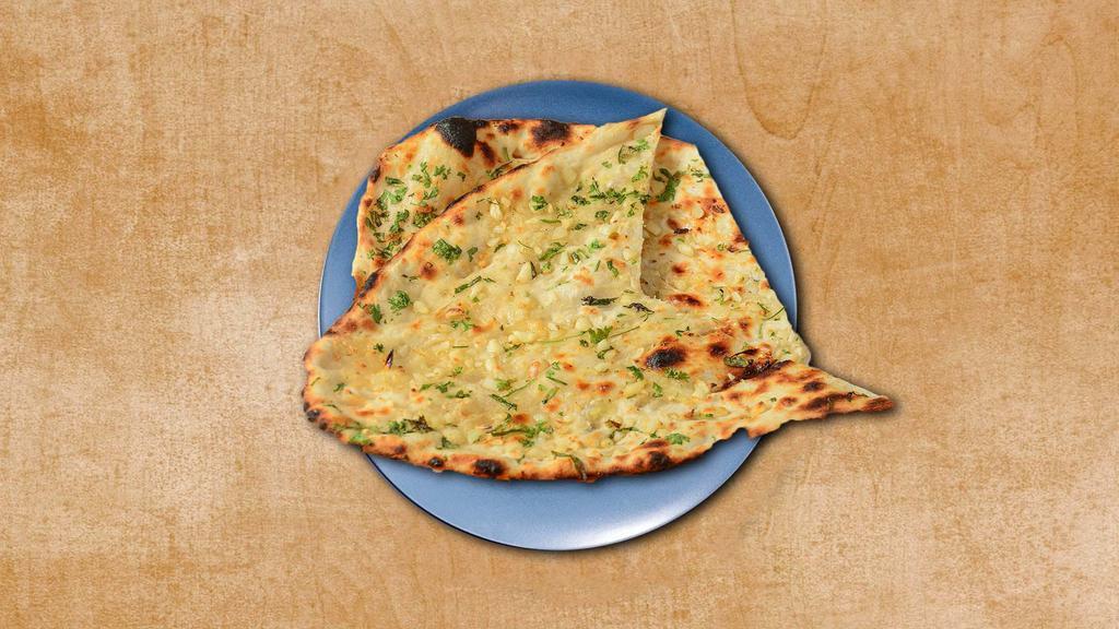 Garlic Naan · A leavened flatbread pressed with minced garlic, baked in a clay oven. A perfect accompaniment to our entrees.