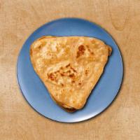 Simple Paratha  · An unleavened flatbread baked over a flat griddle. A perfect accompaniment to our entrees.