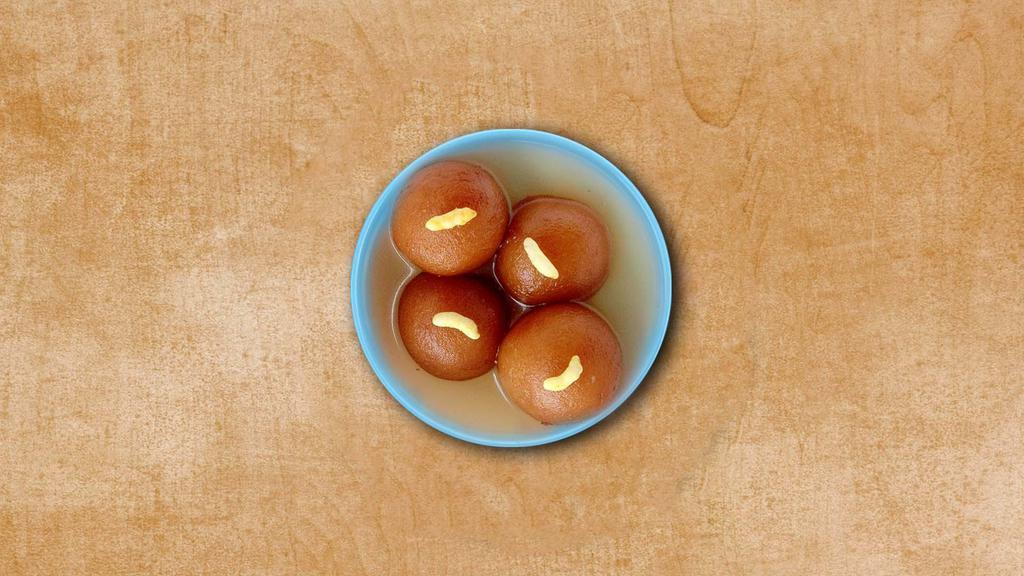 Gulab Jamun · Dumplings made of milk solids, deep-fried, and dipped in cardamom flavored sugar syrup.