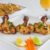 Chicken Chop · Chicken thighs seasoned with herbs and spices, cooked in a clay oven till moist and tender.