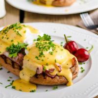 Eggs Benedict · Two Poached Eggs on a Toasted English Muffin with Canadian Bacon and Hollandaise Sauce.