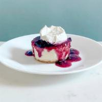 Berry Cheesecake · A delicious New York Style cheesecake served with a mixed berry compote topped with a mascar...