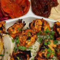 Chicken Kabob Plate · Two skewers of meat served with 4 side salads including hummus, regular salad, spicy eggplan...