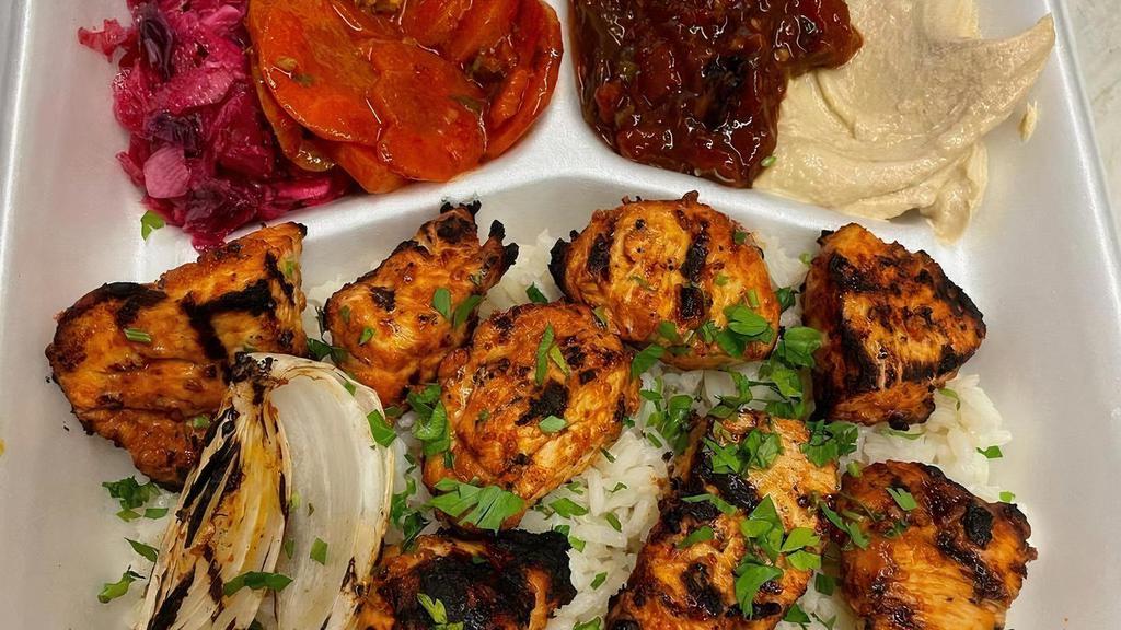 Chicken Kabob Plate · Two skewers of meat served with 4 side salads including hummus, regular salad, spicy eggplant salad or spicy Turkish salad, pickles, cabbage, rice, pita bread and grilled onion.